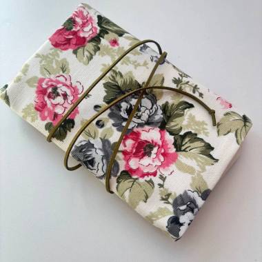 Pink floral knitting needle and crochet hook organizer.